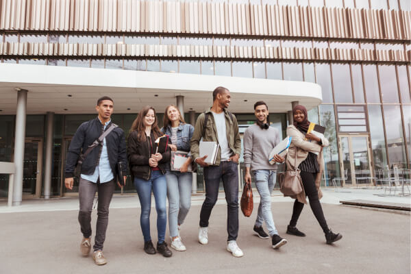 A group of students walking outside a building